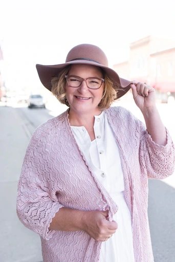 schubring90of92-Edit1-scaled 20 Jenni Schurbing wearing pink hat and cardigan smiling on sidewalk